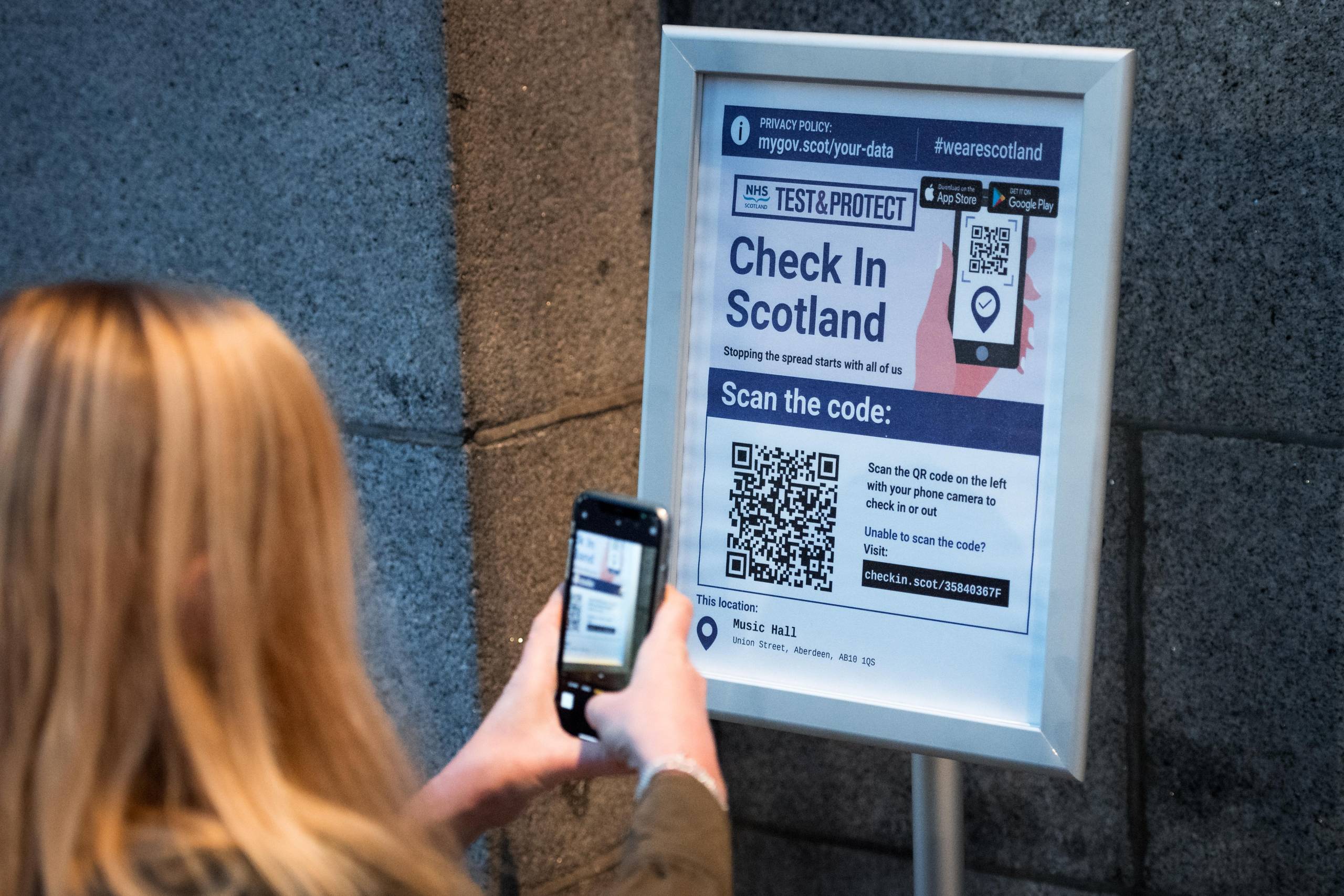 Person scanning a safety sign