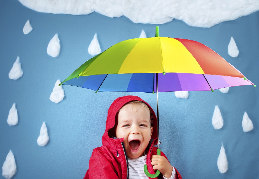 A child with a colourful umbrella under a raincloud
