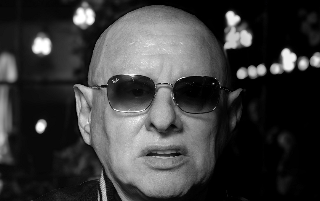 Black and white photo of Shaun Ryder's face wearing sunglasses