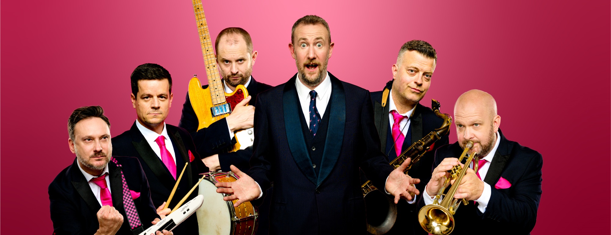 Members of the Horne Section holding their instruments standing against a red background