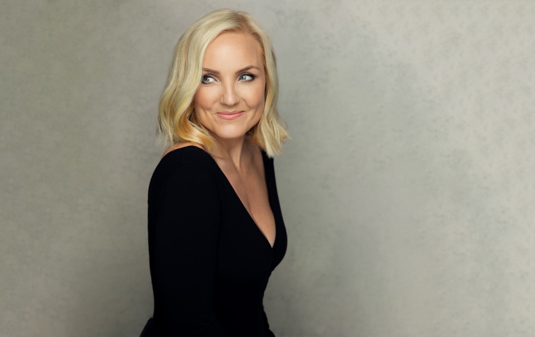 Kerry Ellis in a black top against a grey background