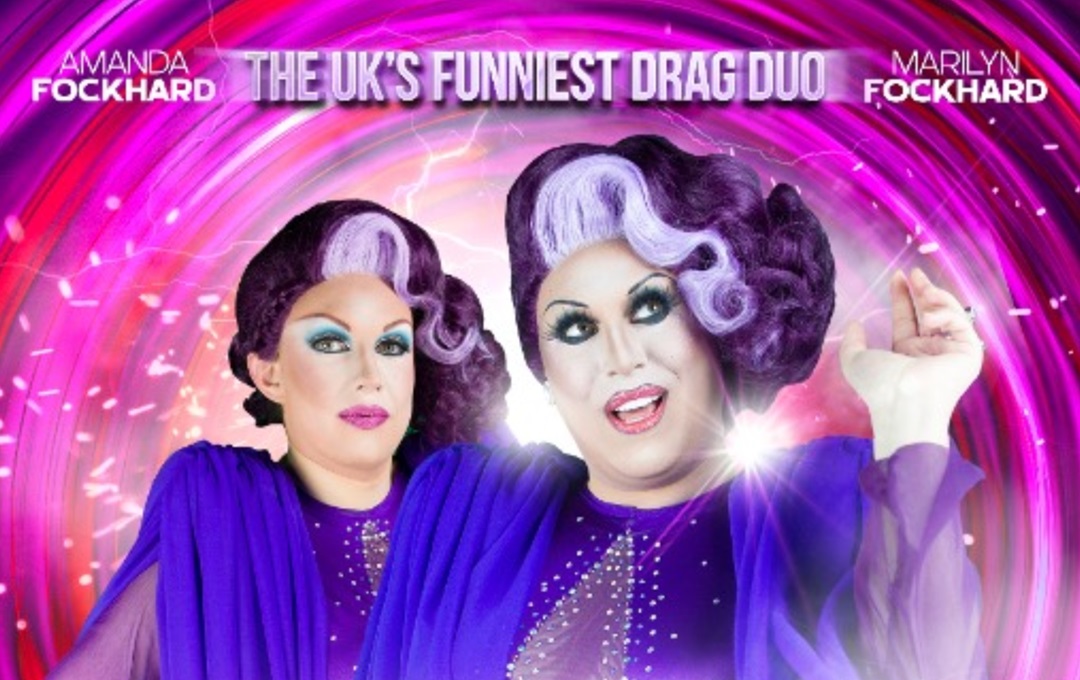 The Absolutely Dragulous performers against a swirly purple background