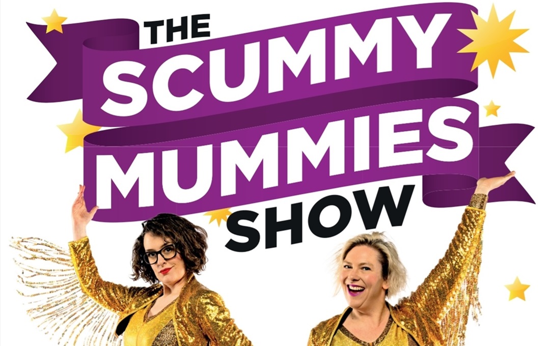 Two performers in gold in front of a sign that says The Scummy Mummies Show