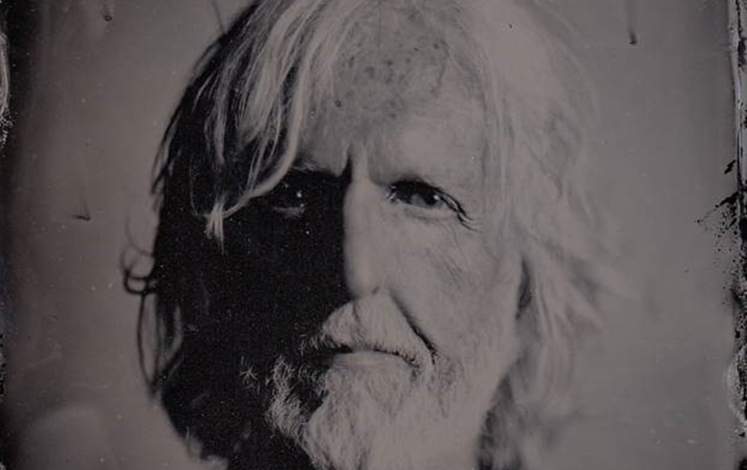 A headshot of Martin McAloon with a grey filter applied to it