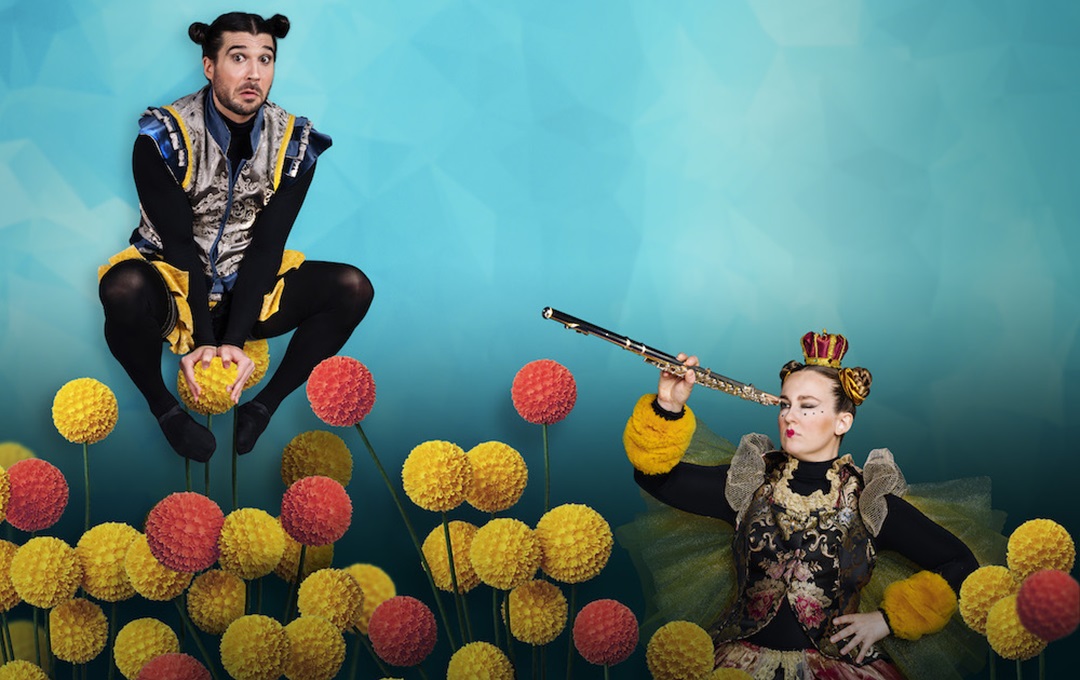 Two people dressed as bees playing with foam balls